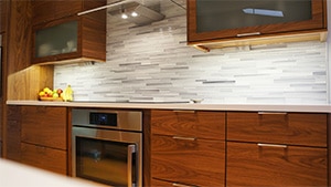 Modern Kitchen Brown Cupboards and White & Grey Offset Backsplash in Mid-Century Kitchen