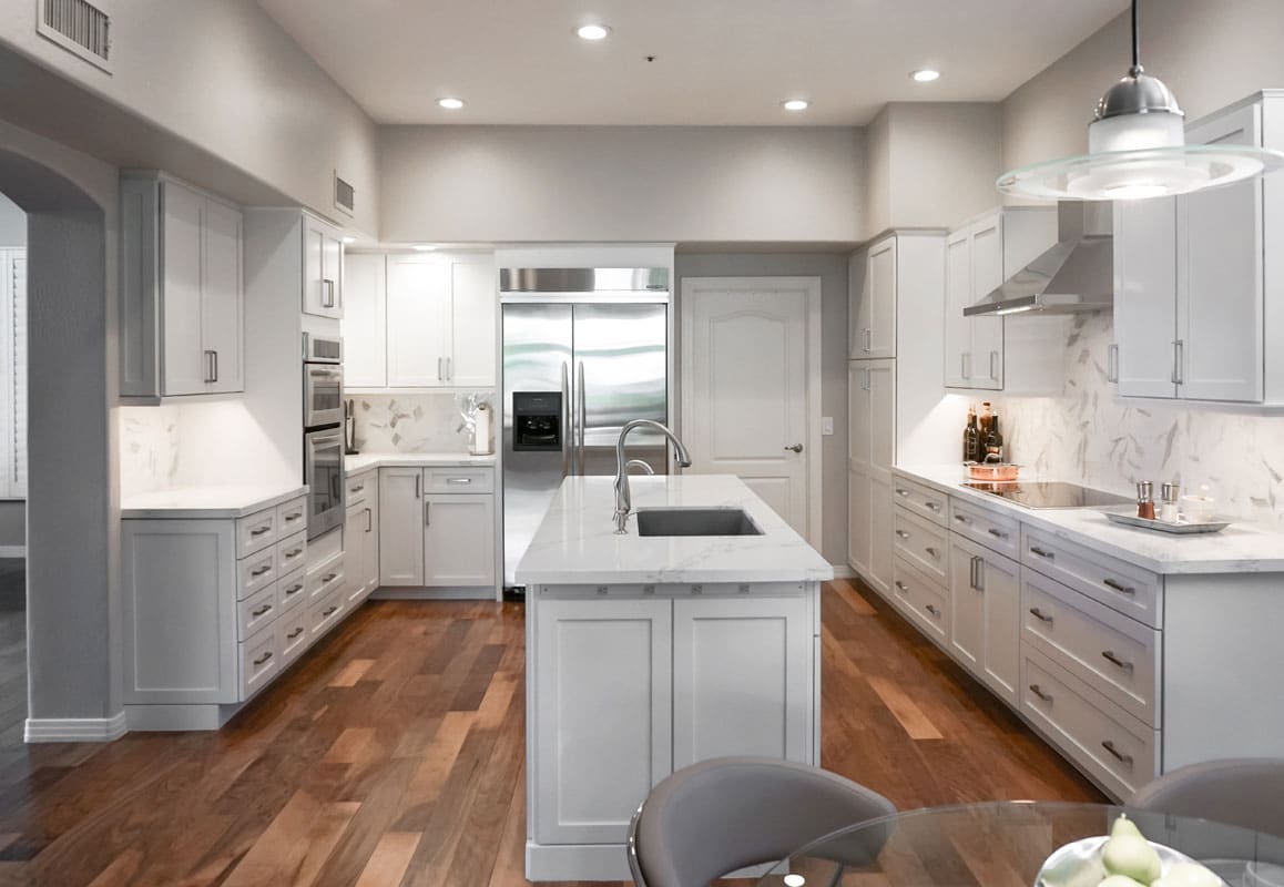 Brown Hardwood floors in Traditional White Kitchen