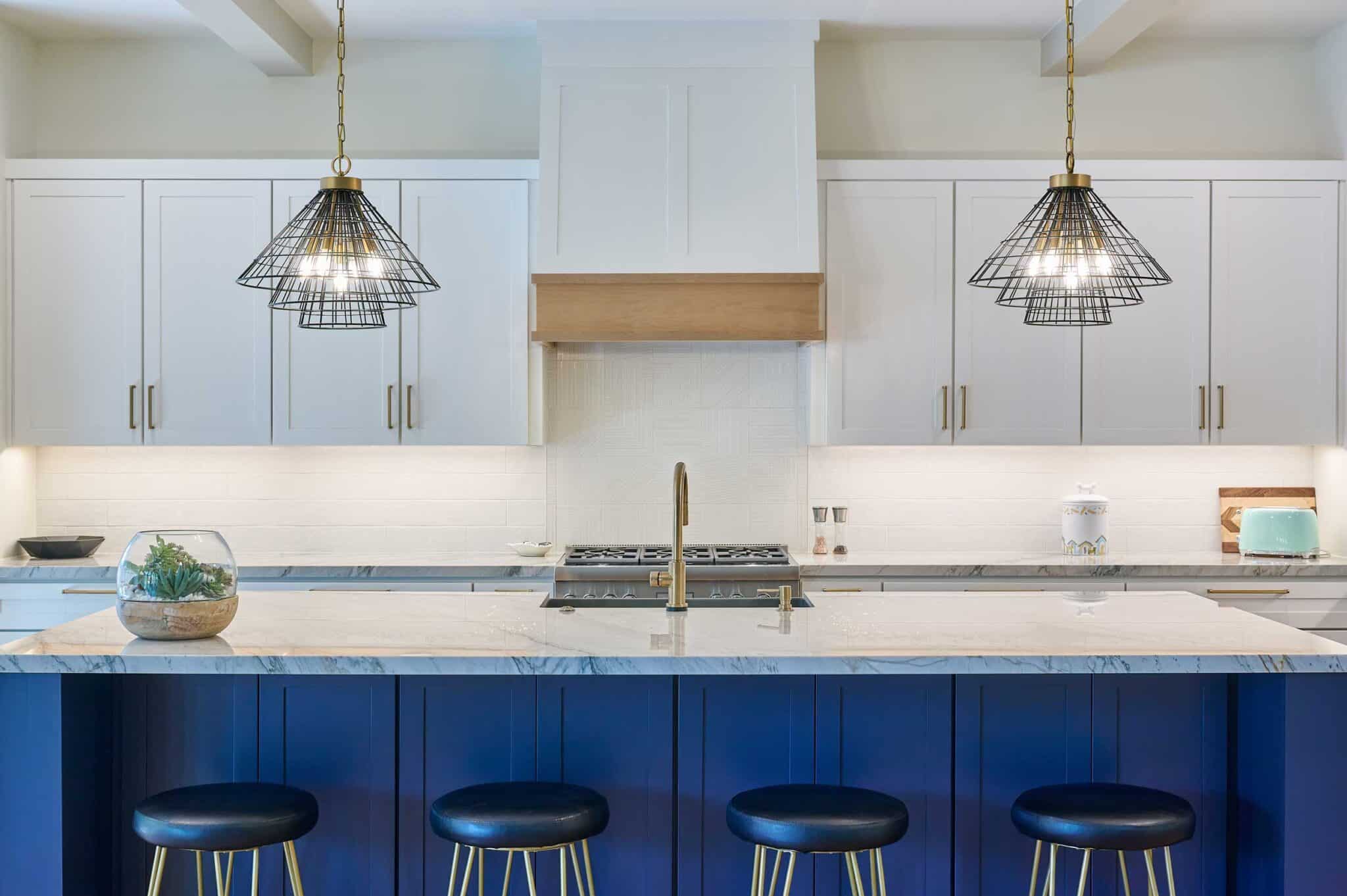 white and navy kitchen with marble countertops