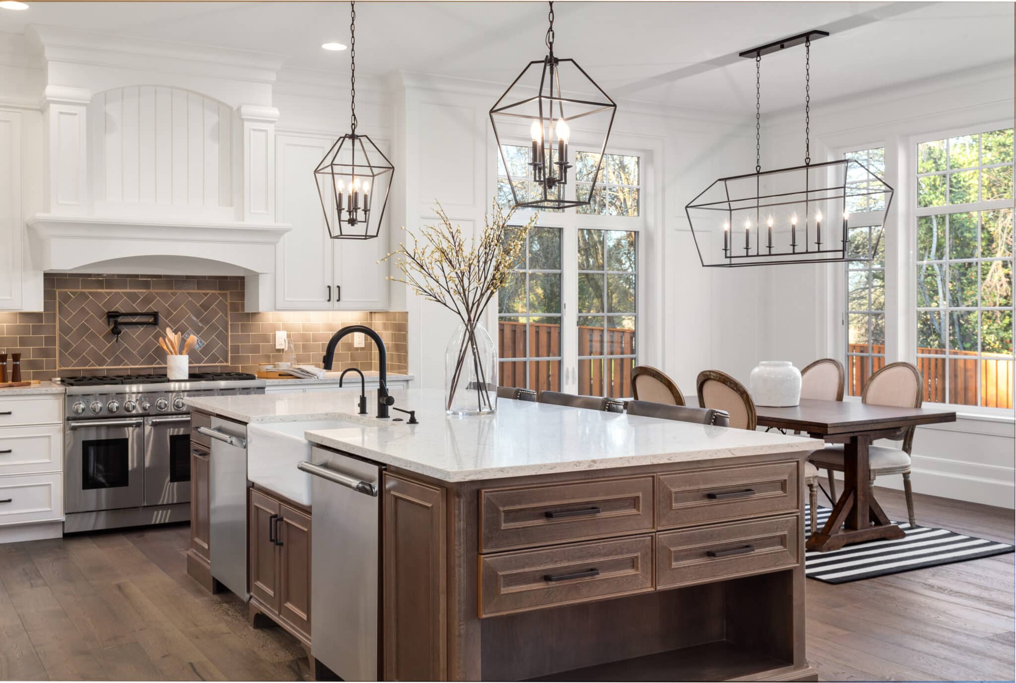 Beautiful kitchen in new traditional style luxury home, with quartz counters, hardwood floors, and stainless steel appliances